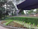 A happy customer uploading garden photos on a sleek, modern booking website.
