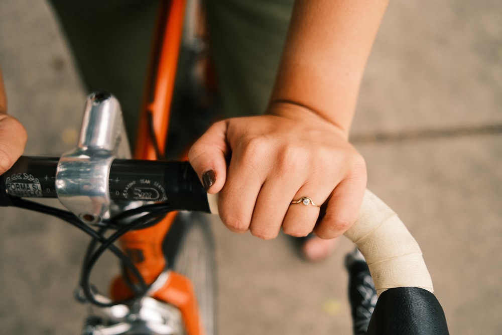 person holding black and silver hand tool