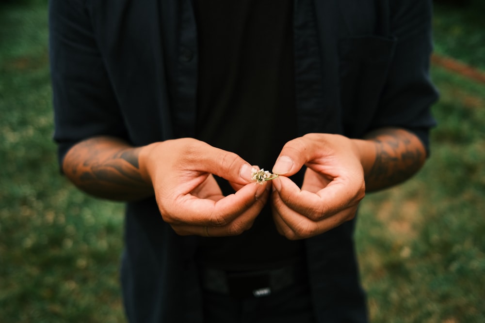 person holding silver diamond ring