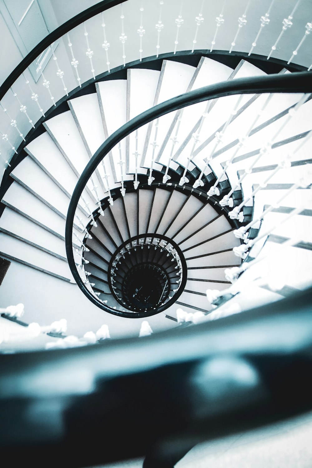 white spiral staircase with black metal railings