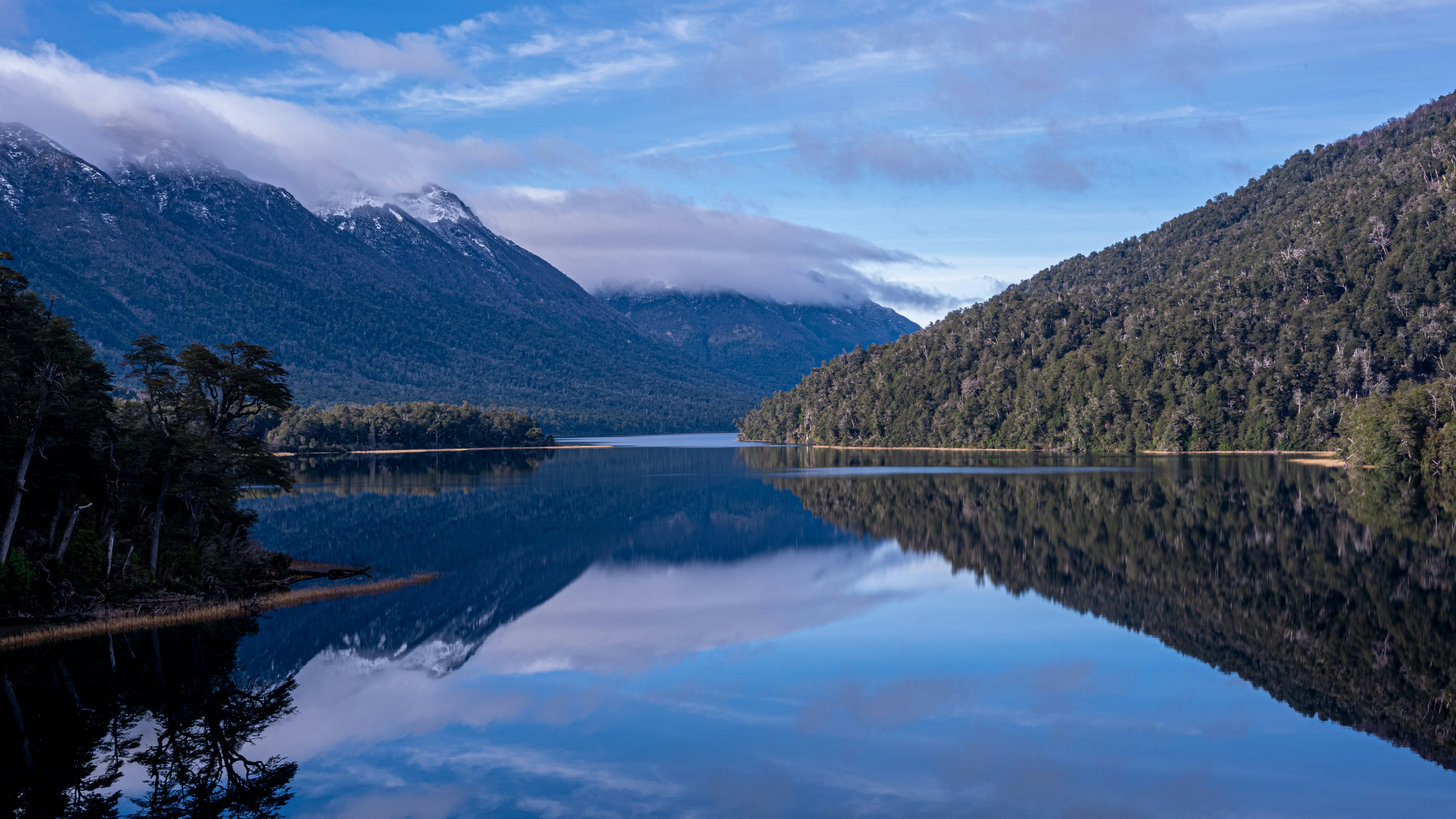 lake near mountain under white clouds during daytime, Mirror lake in Argentinian Patagonia. Midwinter, mountains with snow