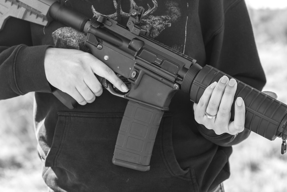 man in black suit holding rifle