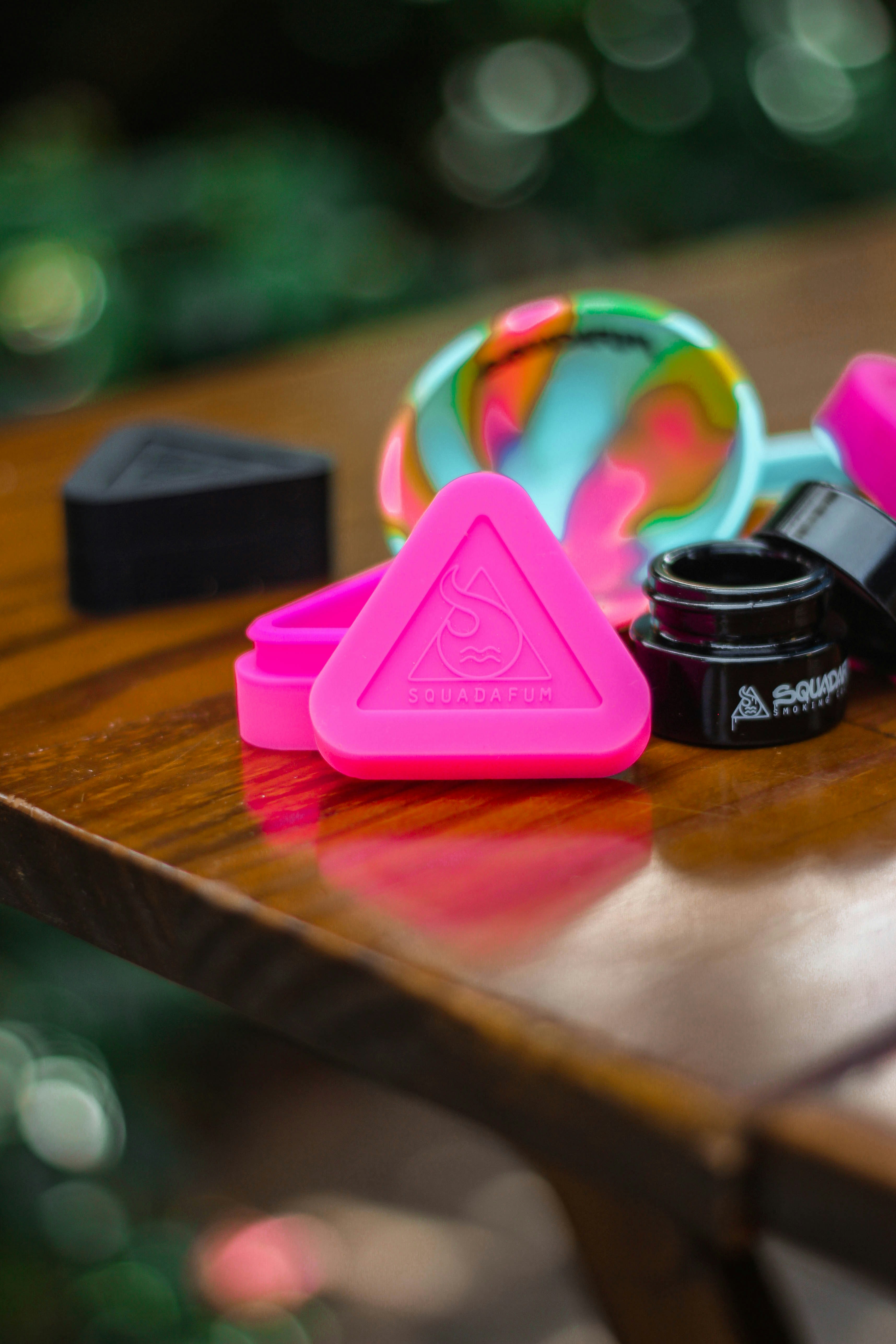 pink plastic heart toy on brown wooden table