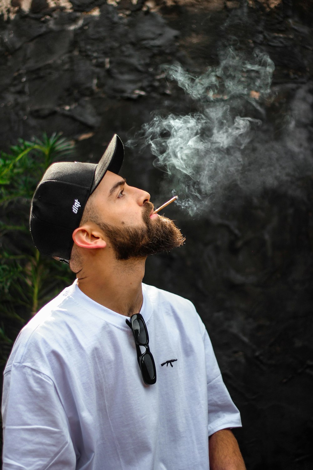 man in white crew neck shirt smoking