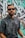 man in black and white floral button up shirt wearing black sunglasses