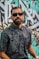 man in black and white floral button up shirt wearing black sunglasses