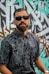 man in black and white floral button up shirt wearing black sunglasses