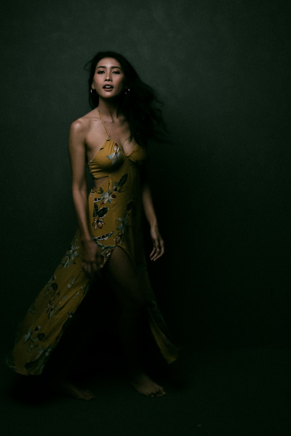 woman in yellow and red floral sleeveless dress