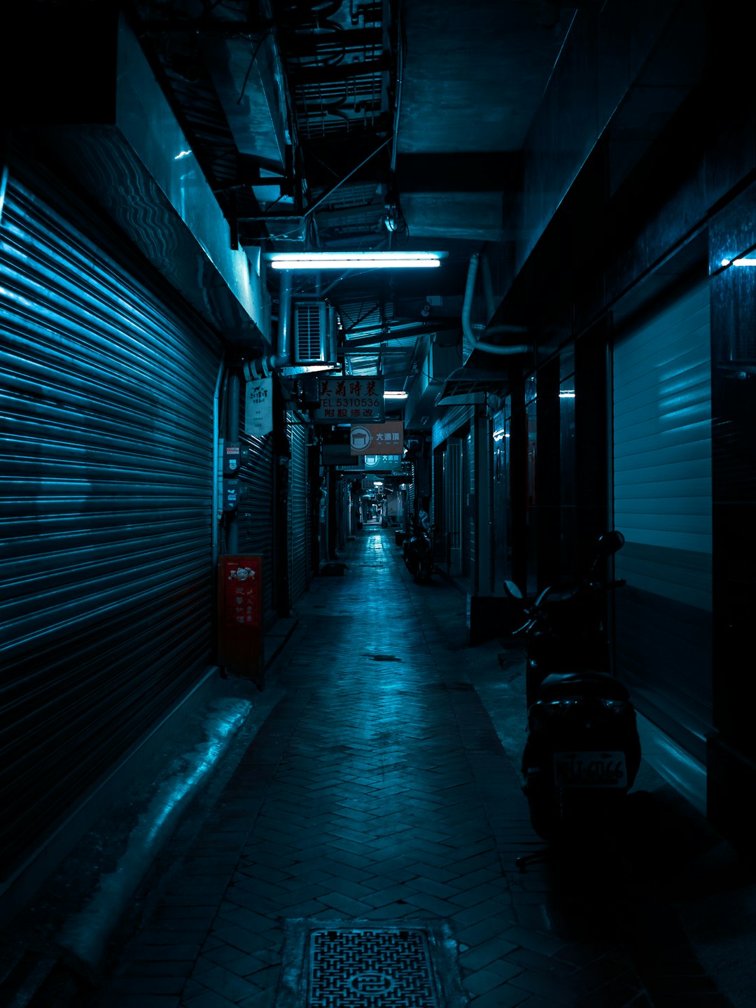 black car parked in front of blue building