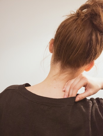 A warm, inviting photo of a person gently massaging their shoulder, symbolizing relief from chronic pain.
