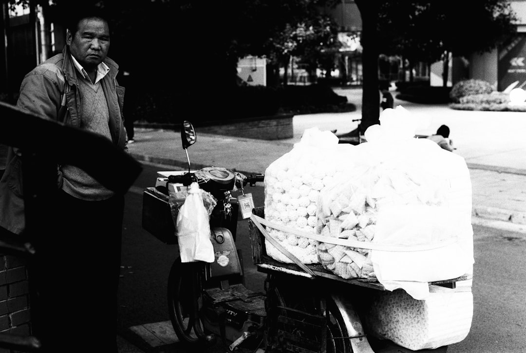 man in black suit riding on black and white motorcycle