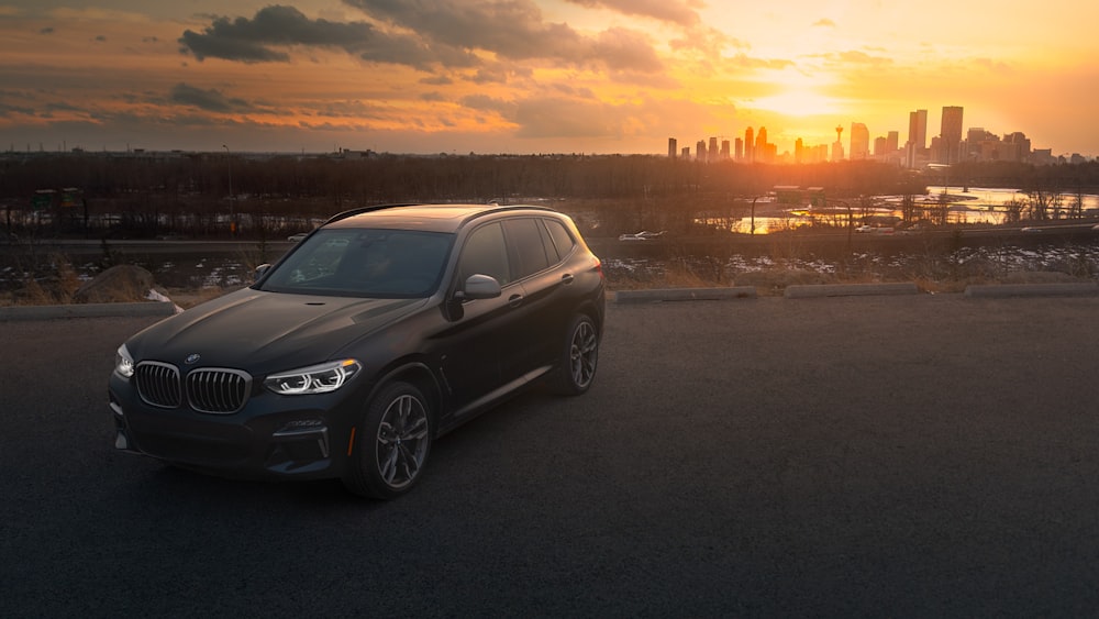 black mercedes benz coupe on road during sunset