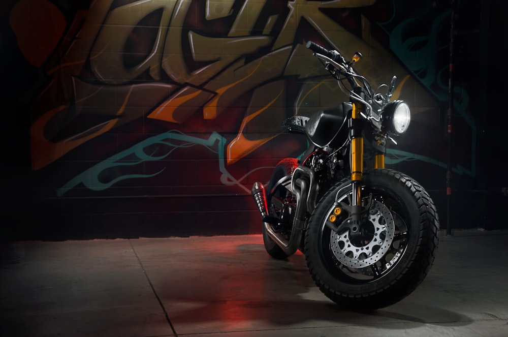 black and red motorcycle in front of brown and red wall