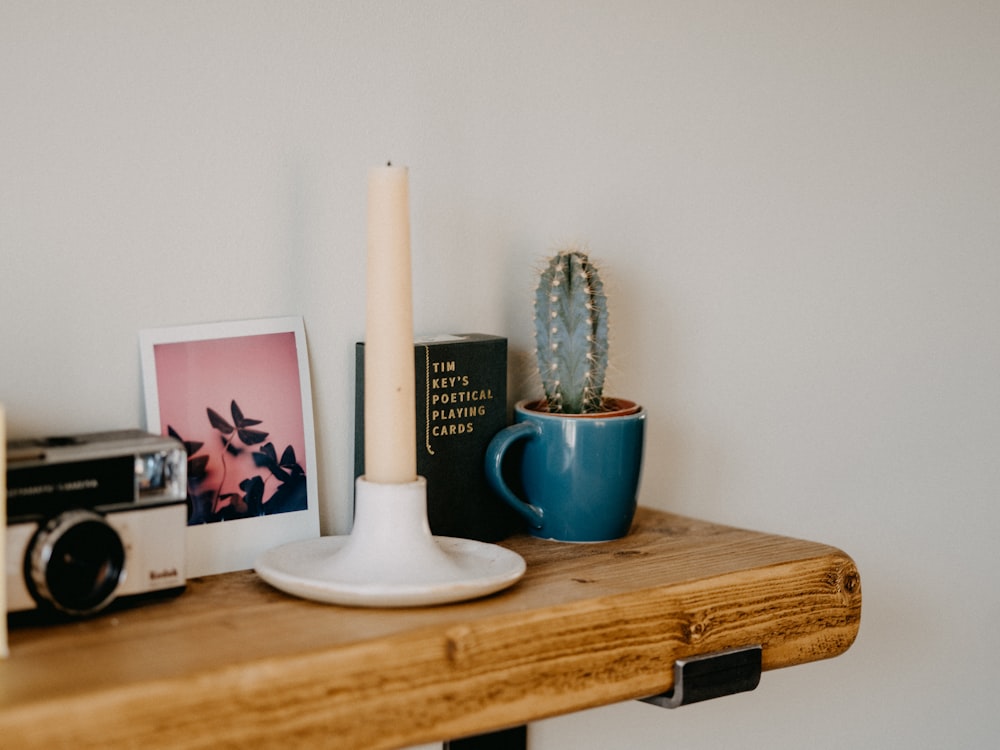 white ceramic candle holder on brown wooden table