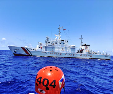 Philippine Coast Guard Auxiliary members conducting a navigation aid maintenance on a lighthouse.