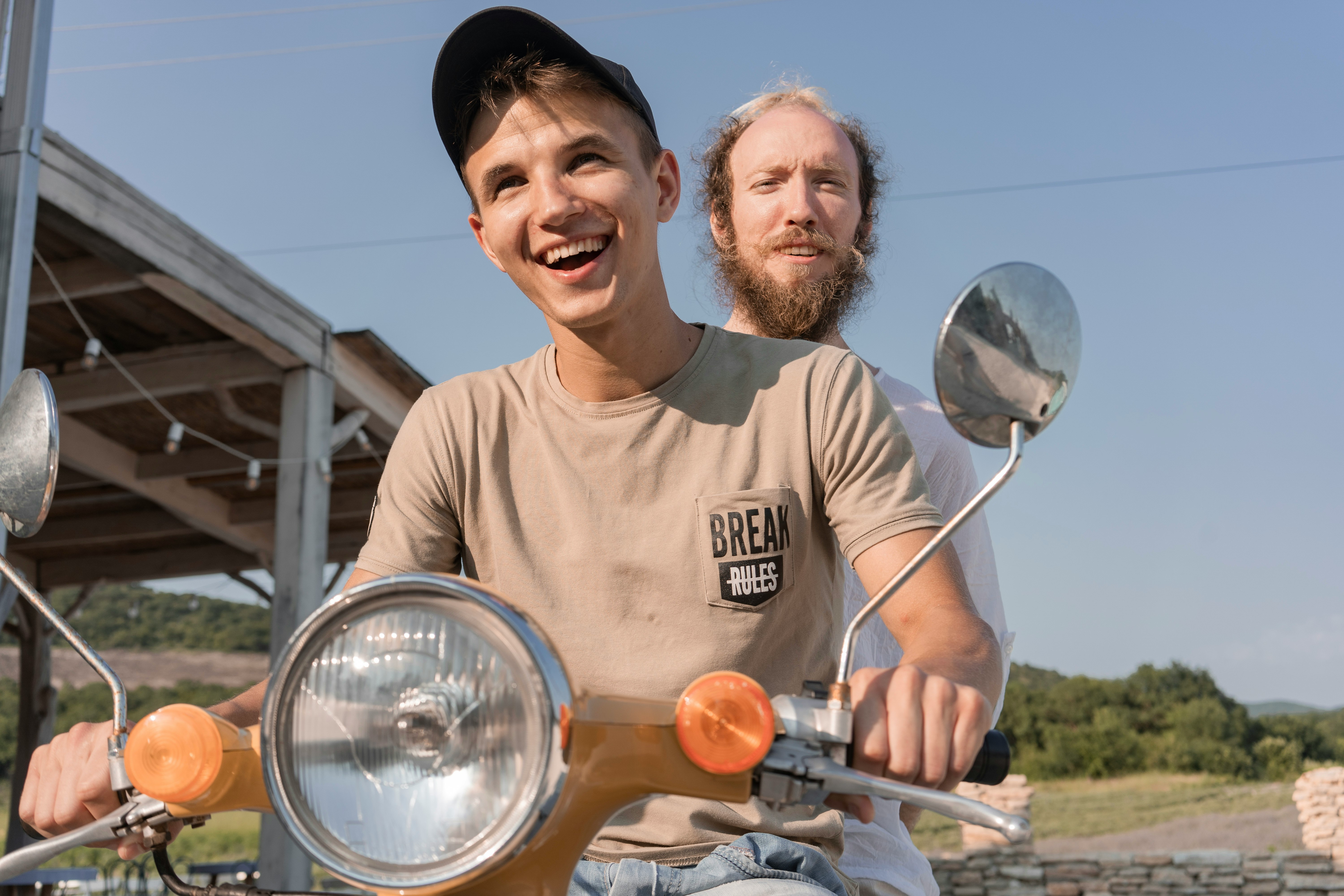 man in brown crew neck t-shirt holding silver balloons