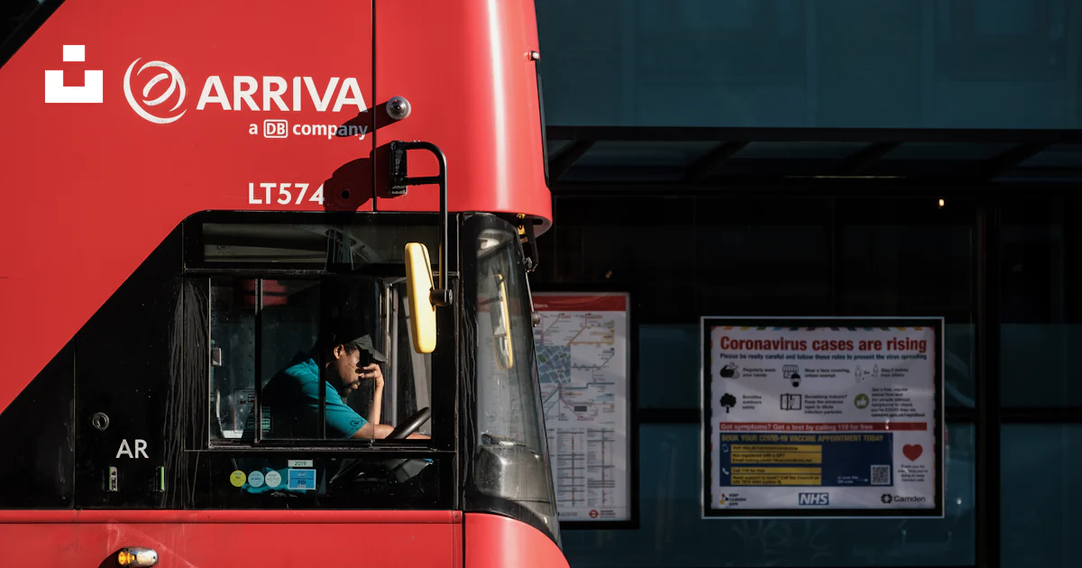 Red and black bus in front of building photo – Free Uk Image on Unsplash