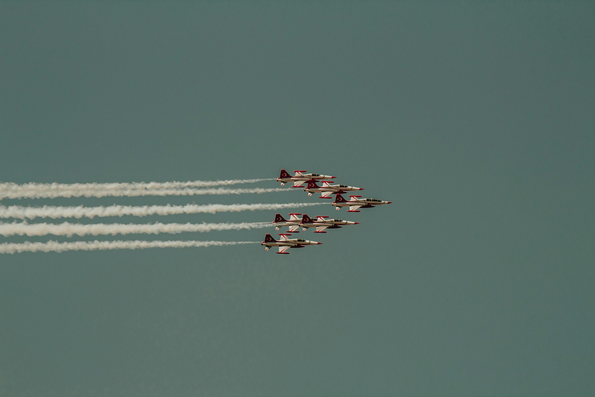 eight white and orange jet planes