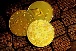 gold round coin on brown textile