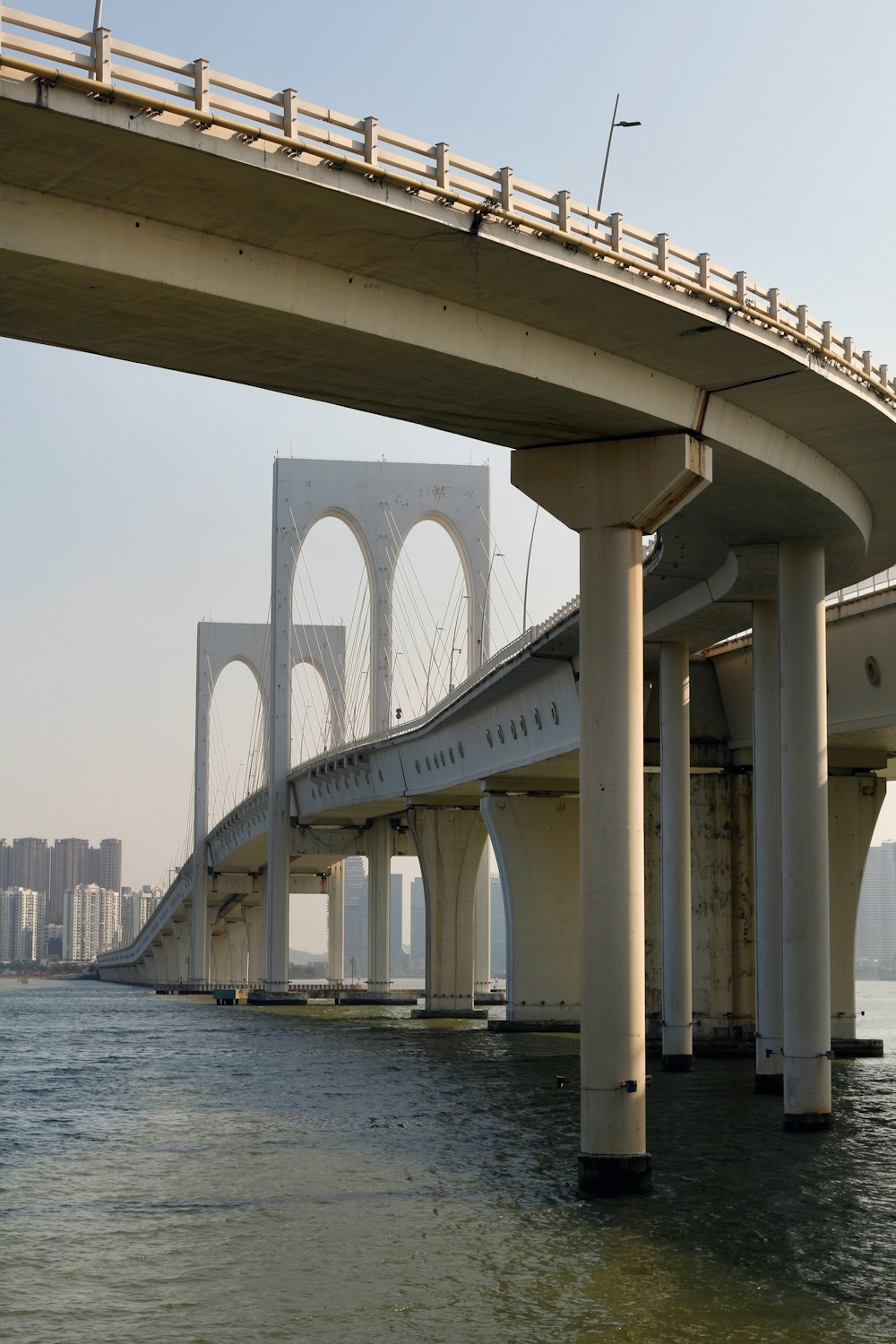 white concrete bridge over body of water during daytime