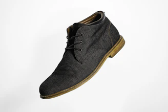 gray and brown suede lace up shoe