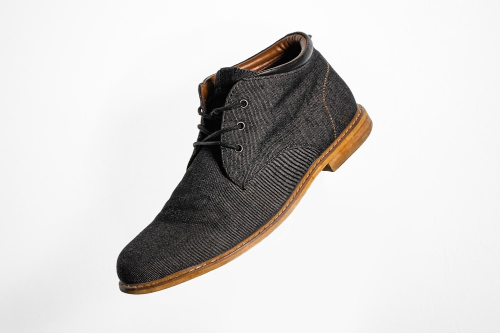 gray and brown suede lace up shoe