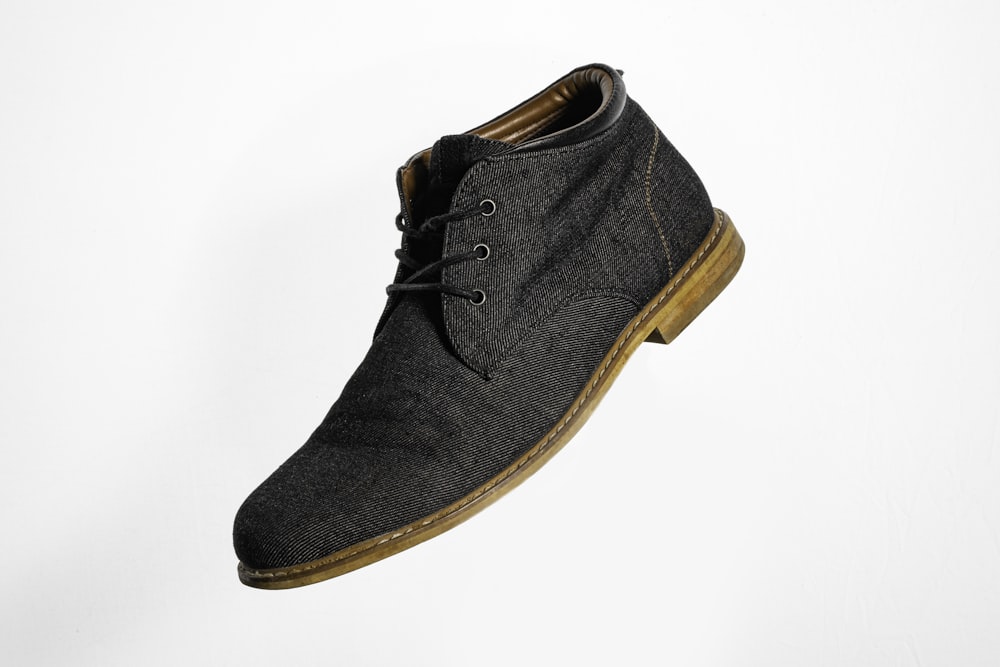 gray and brown suede lace up shoe