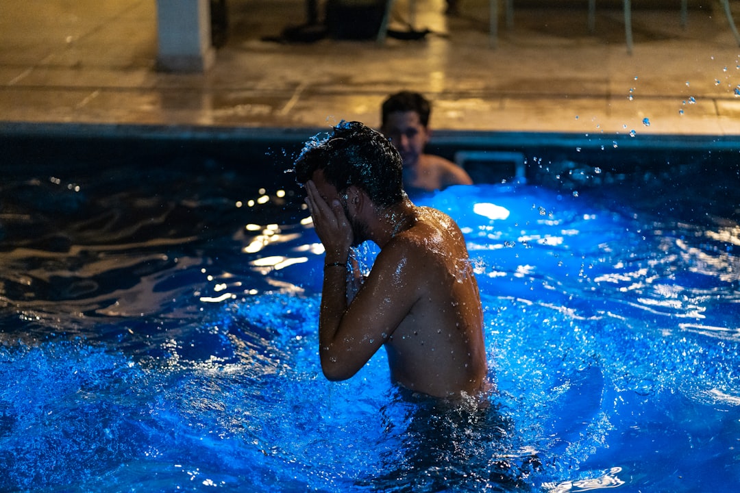 man in swimming pool during daytime