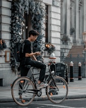 Cyclist using Osseo Wave headphones while riding through an urban street.