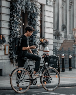 Cyclist using Osseo Wave headphones while riding through an urban street.
