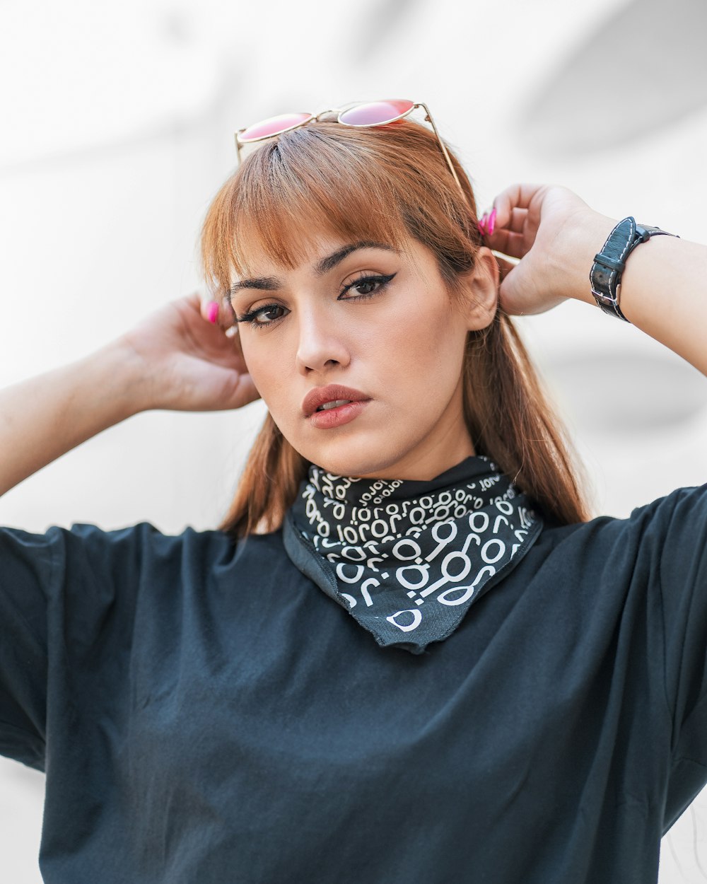 woman in black and white shirt with pink and white hair tie