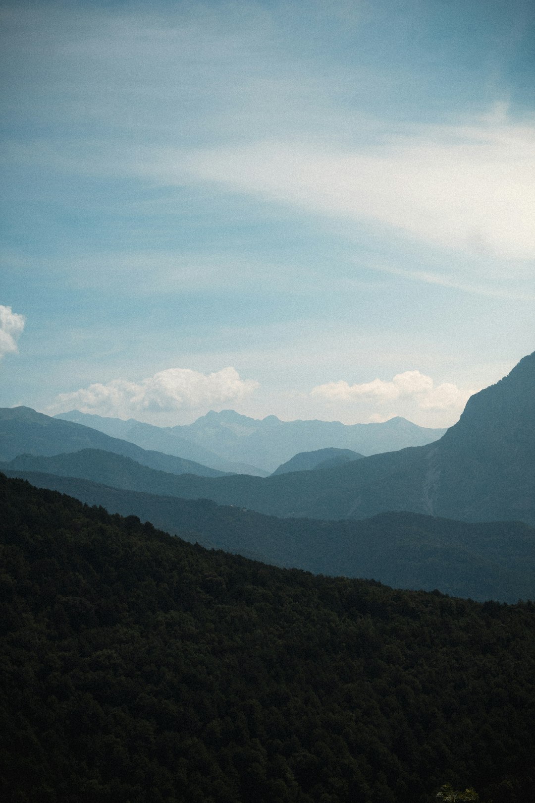 green mountains under white clouds during daytime