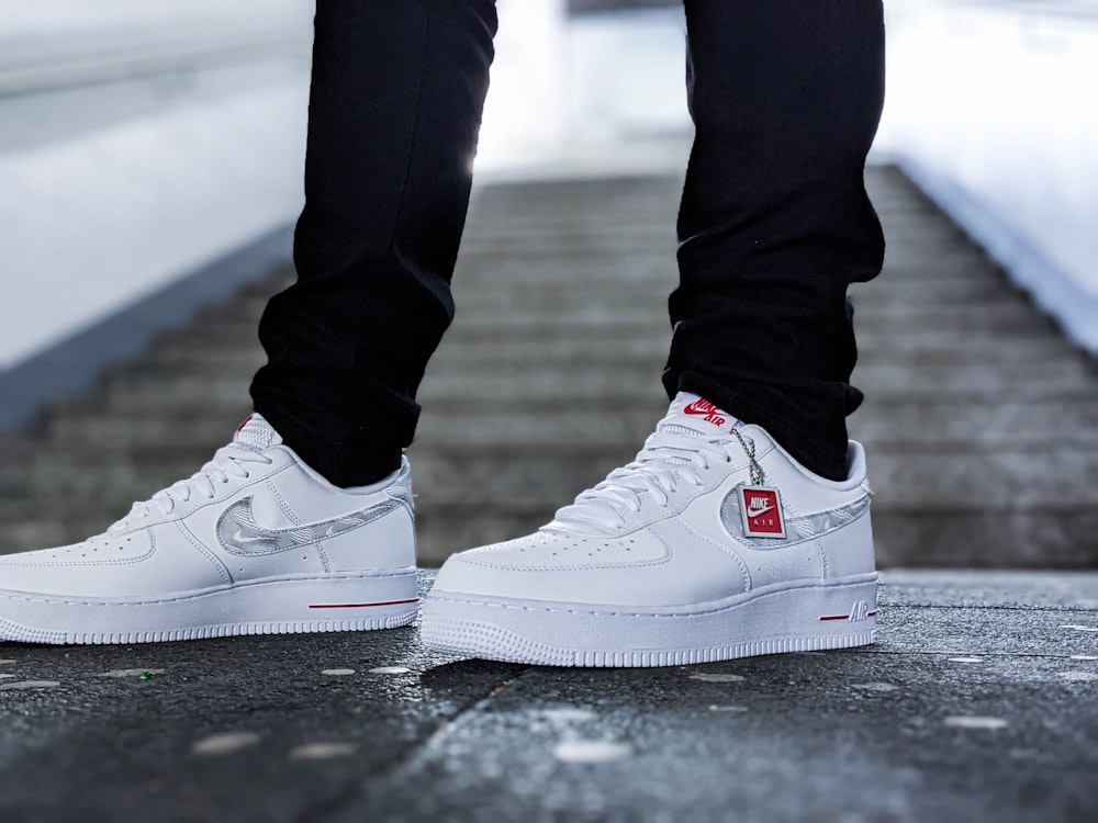 person in white nike air force 1 high