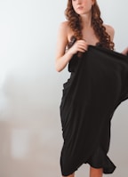 Curly human hair displayed against a soft neutral background.