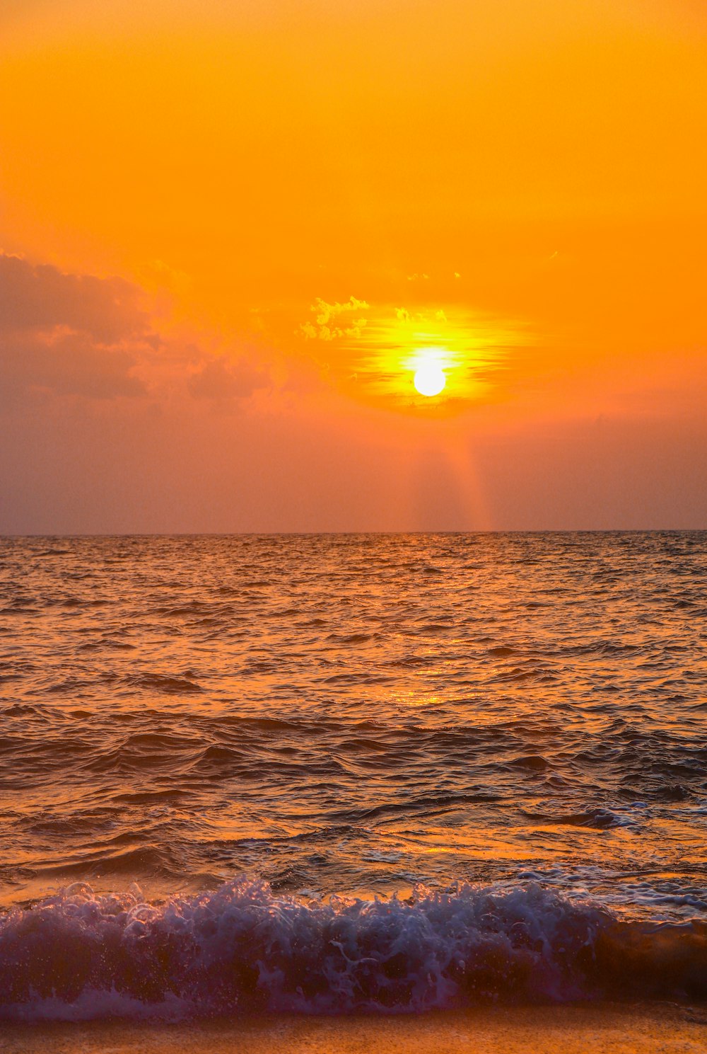 body of water during sunset