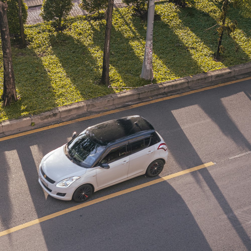 white 5 door hatchback on road during daytime