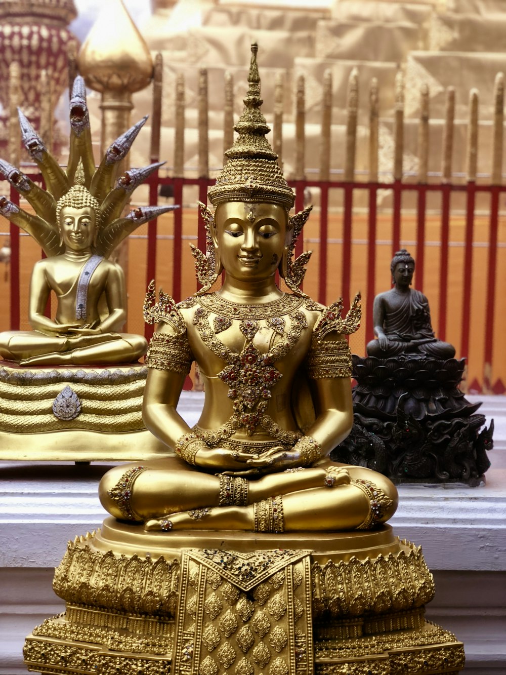 gold hindu deity statue on gray concrete floor