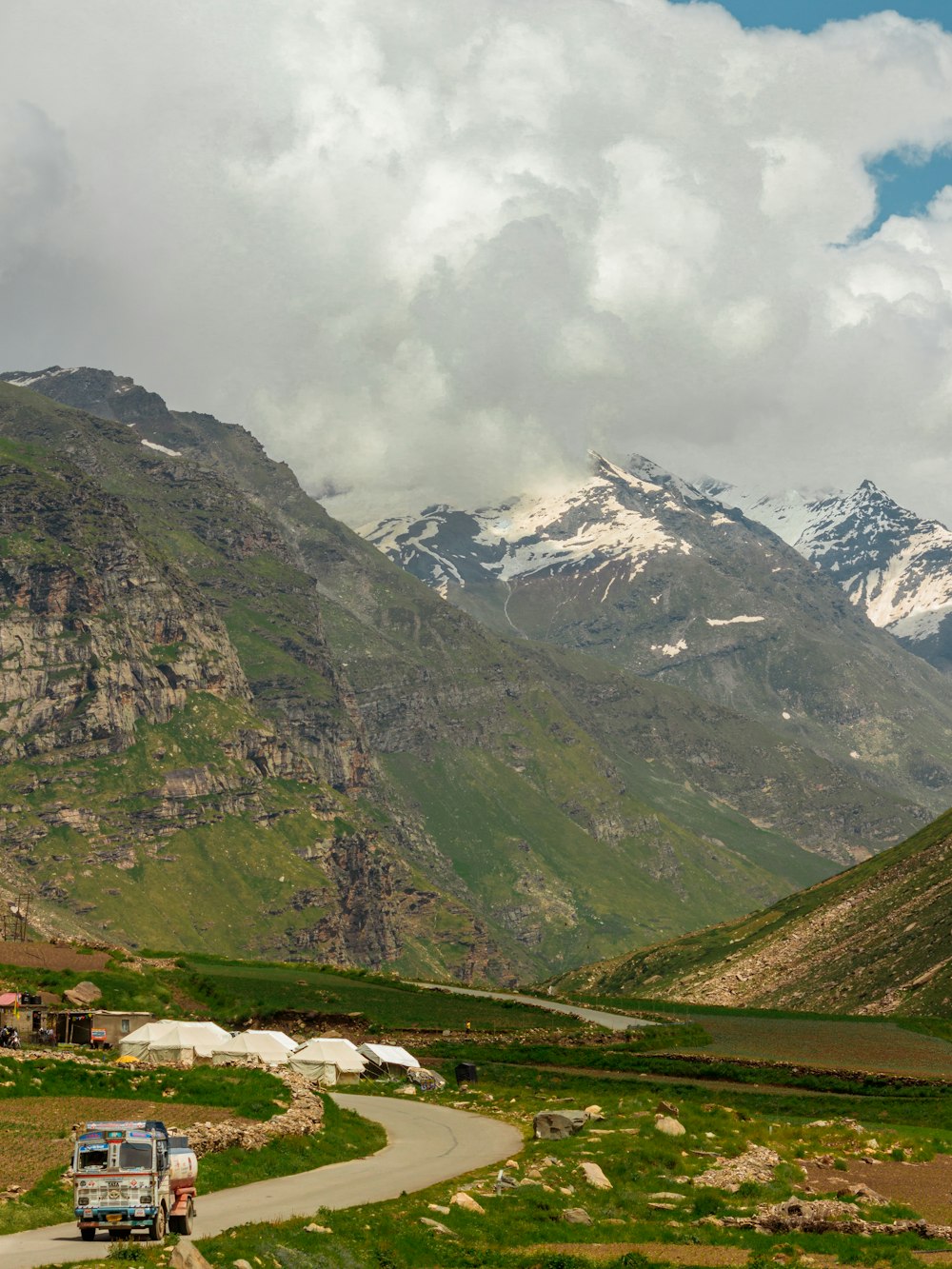 green and white mountains under white clouds during daytime