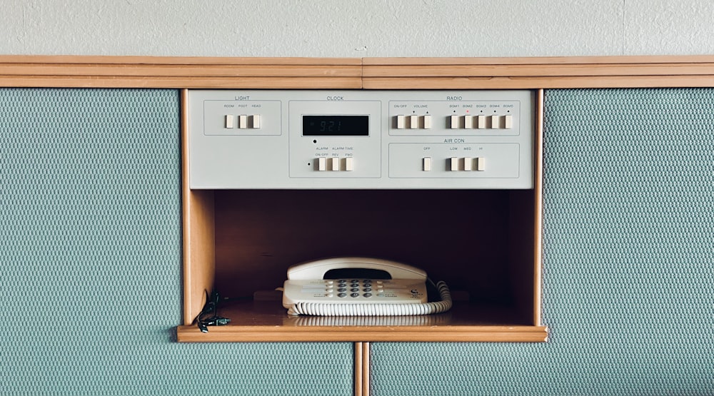 white and black home appliance on brown wooden shelf