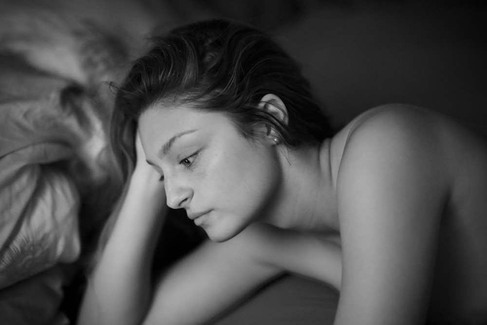 topless woman lying on bed