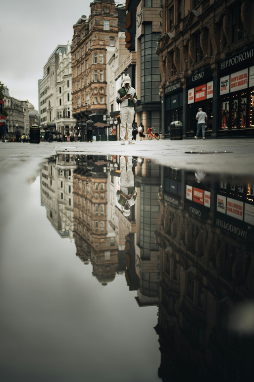 man in white shirt and black pants walking on street during daytime