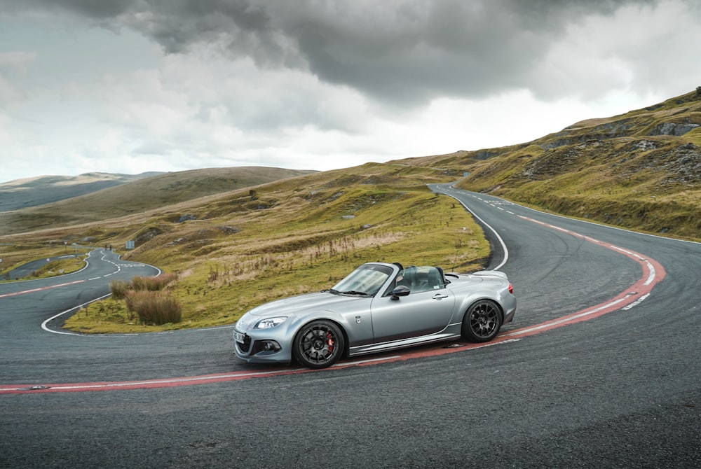 white convertible car on road during daytime