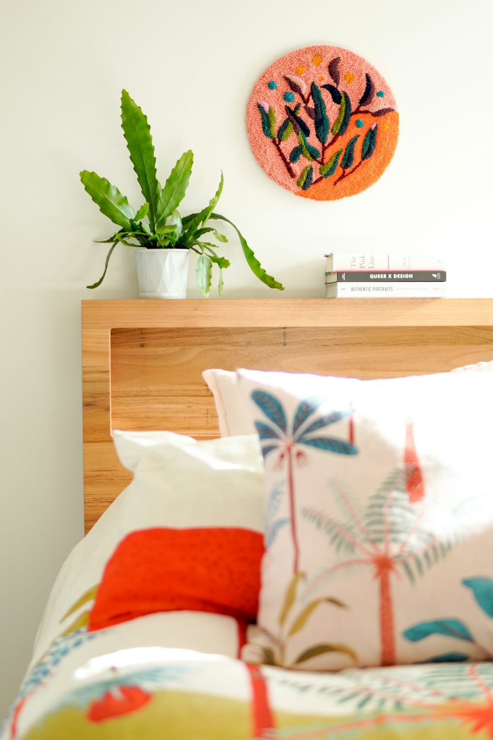 white and orange throw pillows on brown wooden table