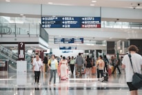 Close-up of a traveler confidently speaking English at an airport counter.