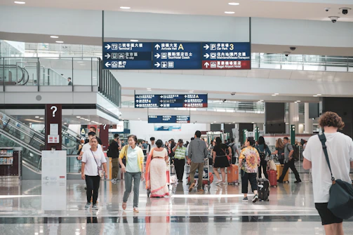 A bustling airport terminal with travelers and influencers in motion.