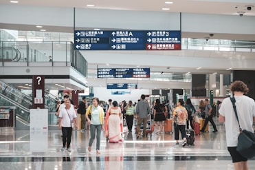 Close-up of a traveler confidently speaking English at an airport counter.