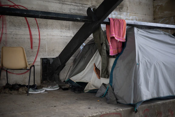 A helpful volunteer at a relief center setting up a durable tent for displaced families.
