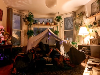 man lying on bed near white tent