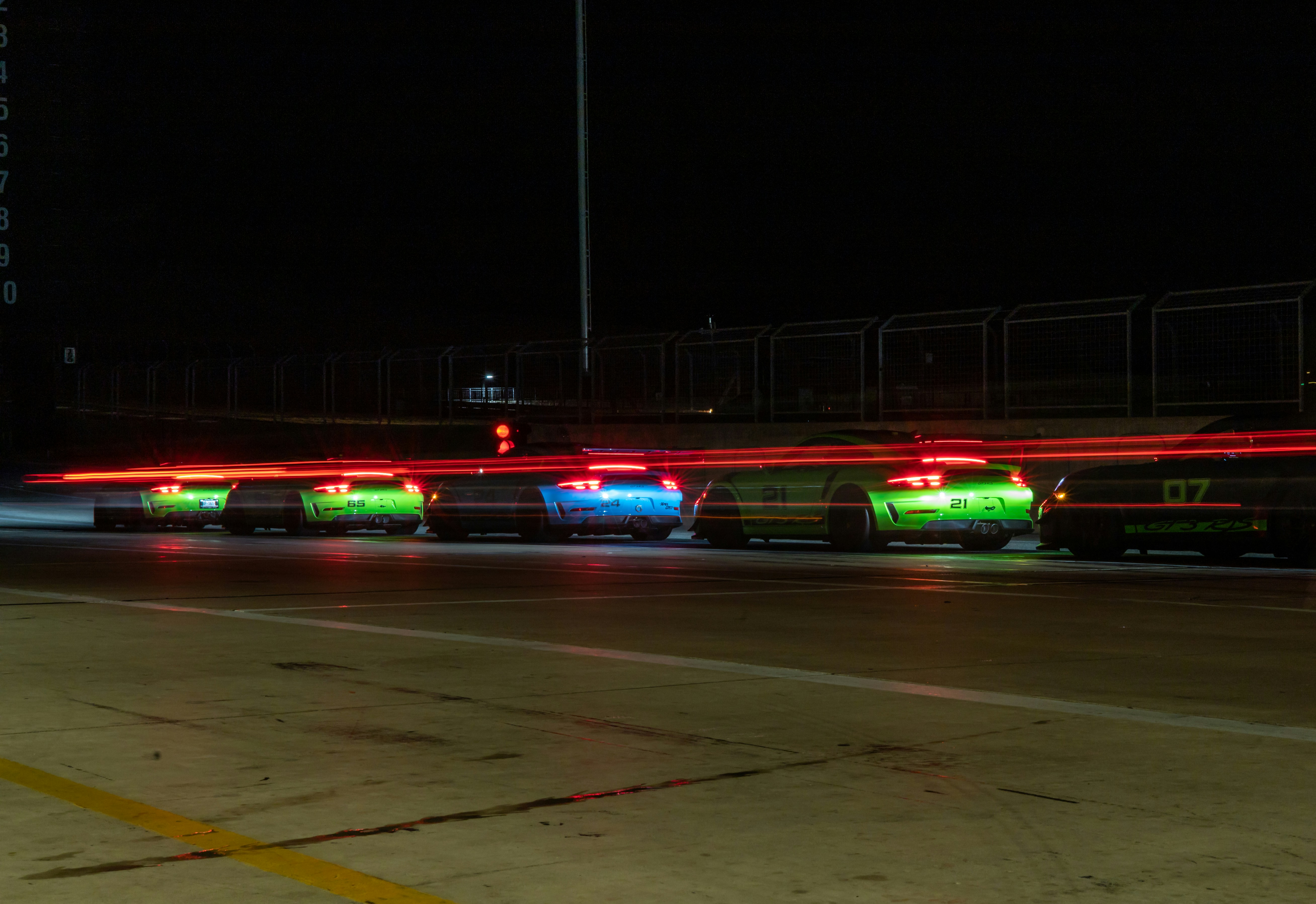 Several electric cars lined up and charging at a public charging station.