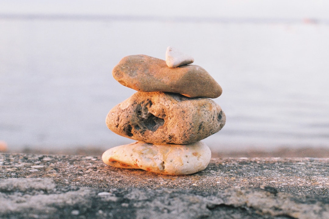 gray stone stack on gray sand, Rocks and stones found at the beach placed one on top of the other. Shot on Film.